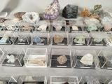 many different types of rocks and minerals in a display case
