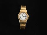 an image of a gold watch with a white face on a black background