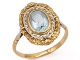 a close up of a gold ring with a blue topaz stone