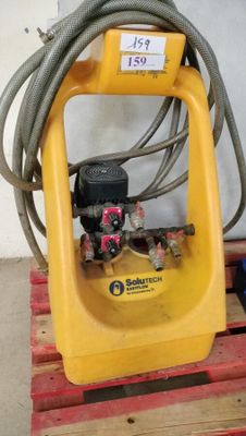 the hose is attached to a yellow machine on a pallet