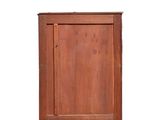 a small wooden cabinet with a door on top of it