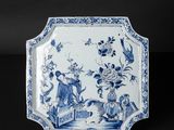 an antique blue and white plate with flowers and birds on it