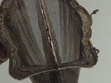 a person holding a mesh strainer in their hand