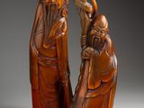 paire de figurines chinoises en bois sculpté représentant un homme et une femme
