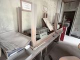 a bed and a chair in a room that is under construction