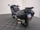a motorcycle that is parked in a room with a checkered floor