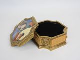 an image of a small gold box with a picture of jesus on it