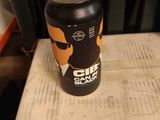 a can of beer sitting on top of a stack of books