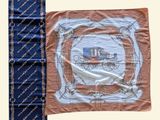 a picture of a blue and orange scarf with a picture of a train on it