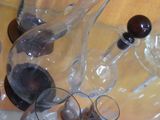 bottles and glasses of wine are sitting on a counter top