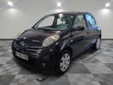 a picture of a small black car parked on a checkered floor