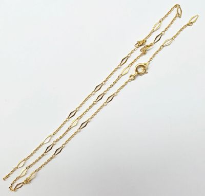 a pair of gold chain bracelets on a white background