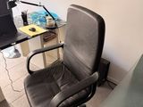 a desk with a chair and a laptop on it