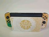 nintendo switch lite with the legend of zeolit logo on the back
