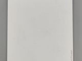 a white notebook sitting on top of a table next to a cup of coffee