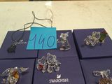 six boxes of swarovski jewelry on a table with a price tag