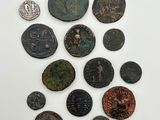 a group of ancient coins on a white surface