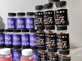 many jars of different flavors of food on a shelf