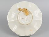 underside view of a plate with a tassel on it