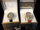 pair of watches in a box on a black background