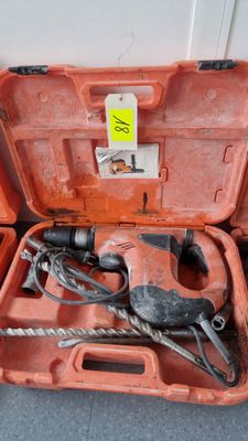 an orange tool case with tools in it sitting on the floor