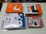 three boxes of cell phones sitting on a table next to each other