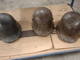 three helmets sitting on top of a cart on the floor