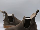 grey sued ankle boots with brown soles on a white background