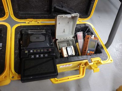 a yellow case filled with electronic equipment on the floor