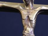 a statue of jesus on a cross with a candle in it