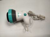 a white and green blow dryer sitting on a table