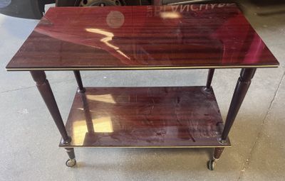 an image of a table with a glass top on wheels