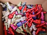 a box full of different colored nail polishes