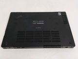 the back of a laptop with a black cover on a white surface