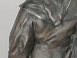 a statue of a man that is holding a bag