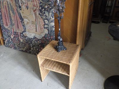 a statue of a man standing on a stool next to a chair