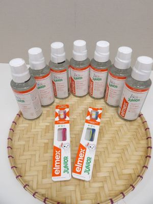 bottles of toothpaste and toothpaste paste on a bamboo tray