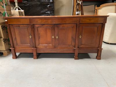a wooden cabinet that is sitting in the middle of a room