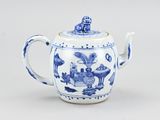 a blue and white teapot with a lid on a table