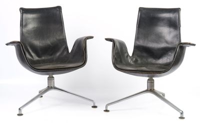 pair of black leather chairs on castors with metal legs