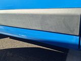 a close up of a car door with a number plate on it
