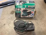 a box of power tools on the floor next to a corded cord