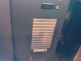 an air conditioner sitting on top of a wooden floor next to a wall