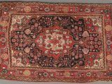 un tapis persan ancien aux couleurs rouge et noir
