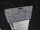 a label on the back of a black refrigerator