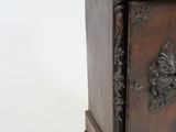 a wooden cabinet with a carved design on the front