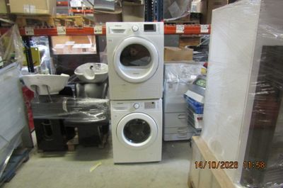a stack of washers and dryers in a store
