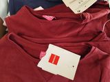 several t - shirts are stacked on top of each other on a table