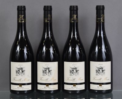 four bottles of wine are lined up on a glass table