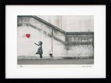 framed picture of a girl with a red balloon in a black frame